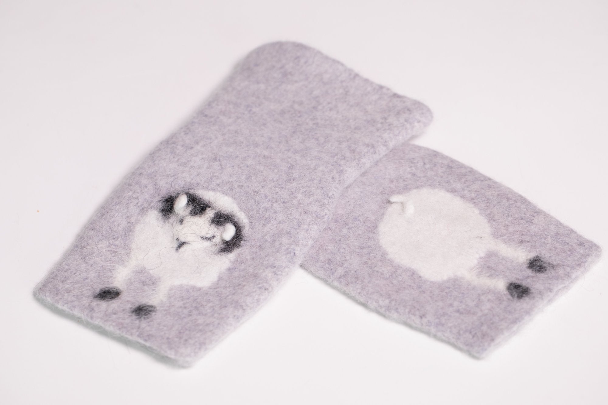 Warm and soft half mittens with cute sheep pattern. Handmade in Iceland. Colour light grey