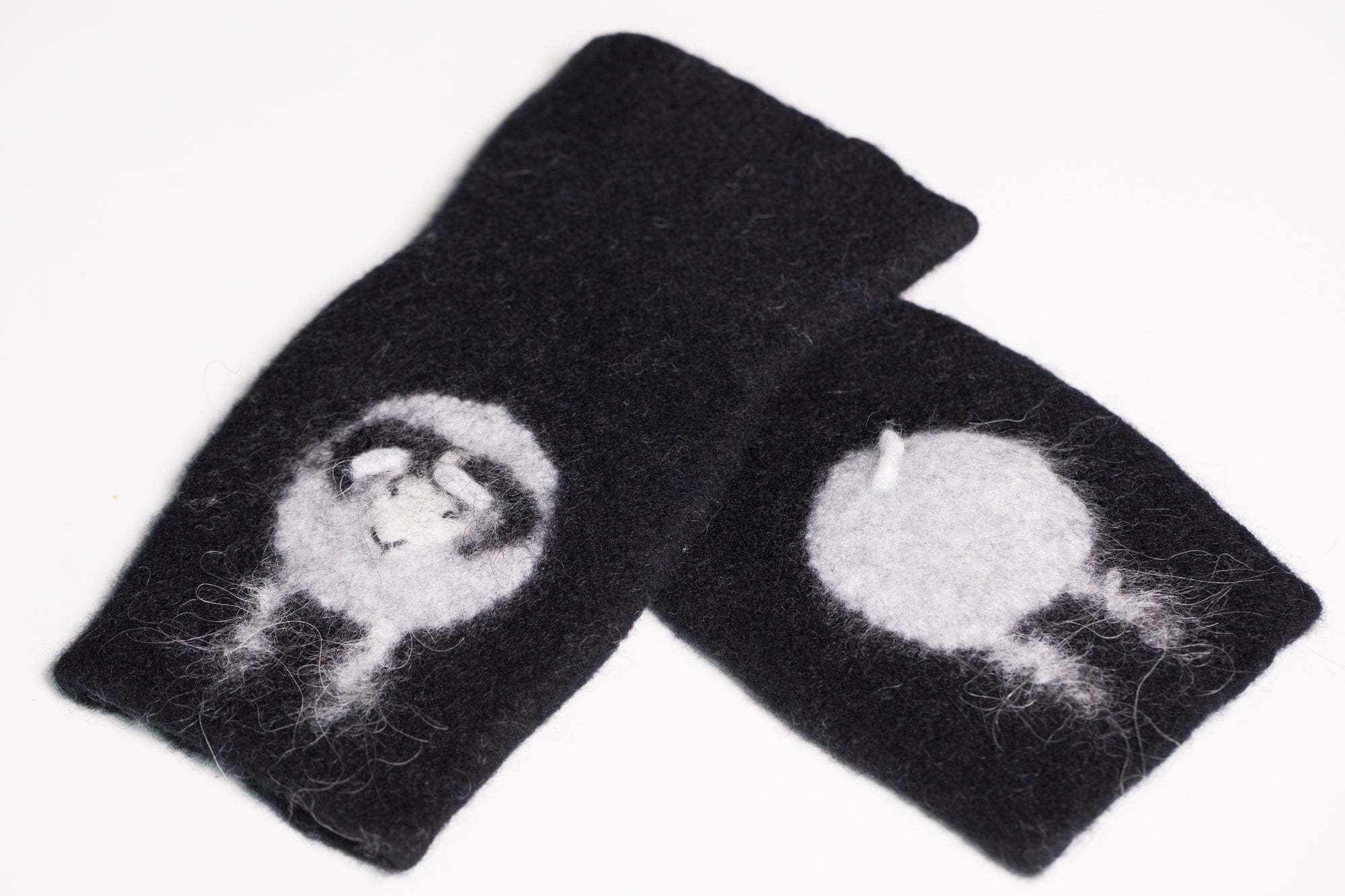 Warm and soft half mittens with cute sheep pattern. Handmade in Iceland. Colour black.