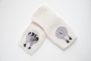 Warm and soft half mittens with cute sheep pattern. Handmade in Iceland. Colour white.